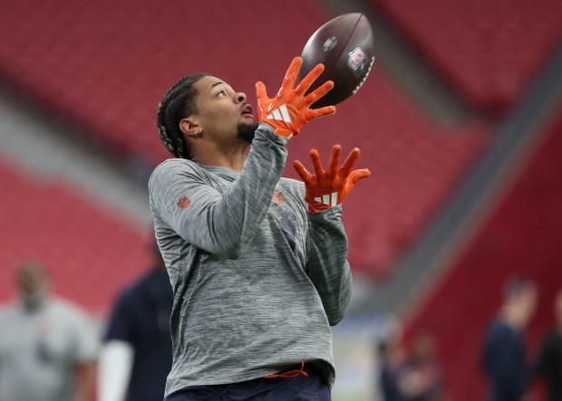 Chicago Bears wide receiver Rome Odunze warms up to face...