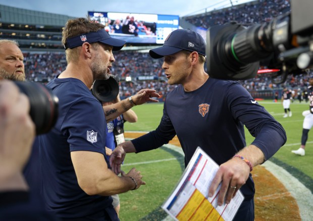 Dallas Cowboys head coach Brian Schottenheimer, left, meets Chicago Bears...