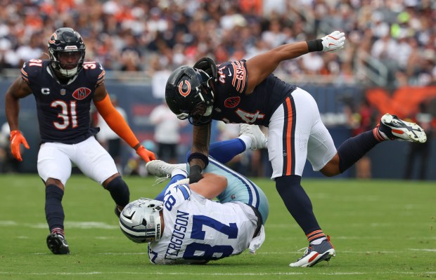 Chicago Bears linebacker Noah Sewell (44) tackles Dallas Cowboys tight...