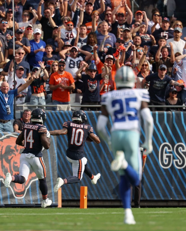 Chicago Bears wide receiver Luther Burden III (10) scores a...