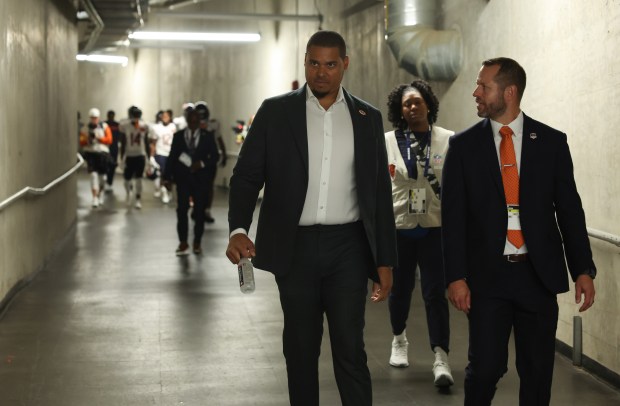 Bears general manager Ryan Poles, center, heads to the field for a game against the Lions at Ford Field on Sept. 14, 2025, in Detroit. (John J. Kim/Chicago Tribune)