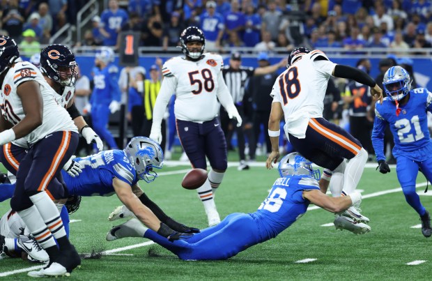 Bears quarterback Caleb Williams is tackled by Lions linebacker Jack...
