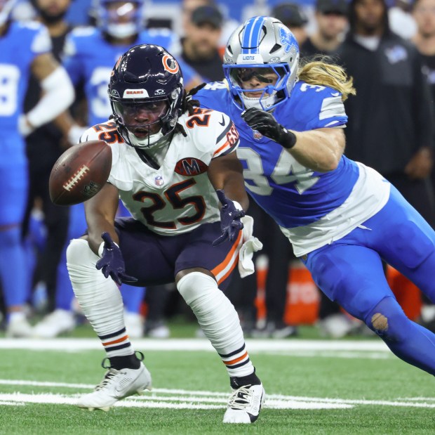 Bears running back Kyle Monangai reaches for the ball on...