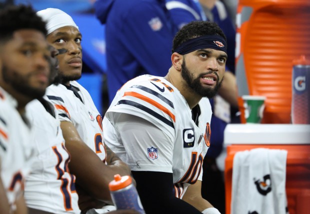 Bears quarterback Caleb Williams watches from the bench in the...