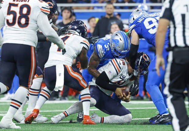 Bears quarterback Caleb Williams is sacked by Lions safety Brian...