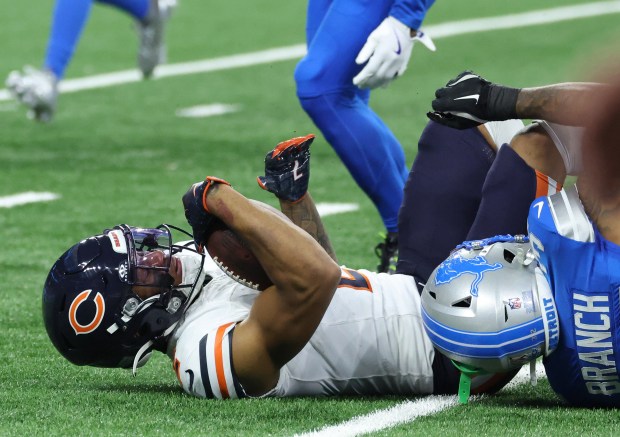 Bears wide receiver DJ Moore is tackled by Lions safety...