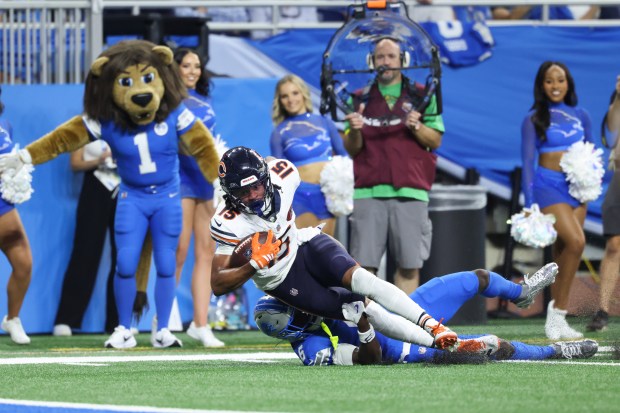 Bears wide receiver Rome Odunze is tackled by Lions cornerback...