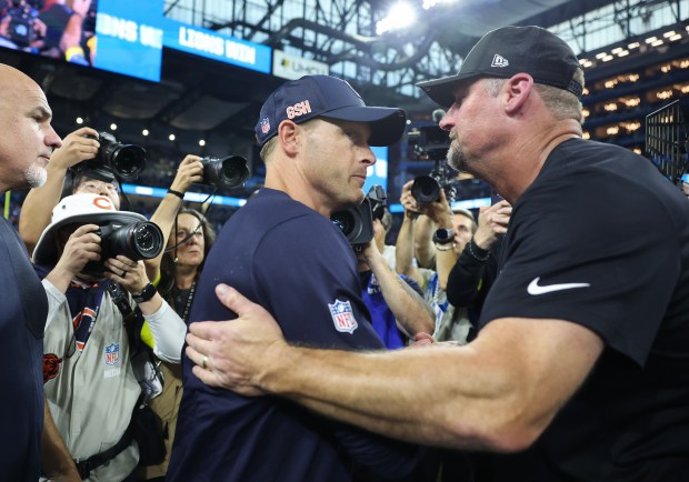 Bears coach Ben Johnson, left, and Lions coach Dan Campbell...