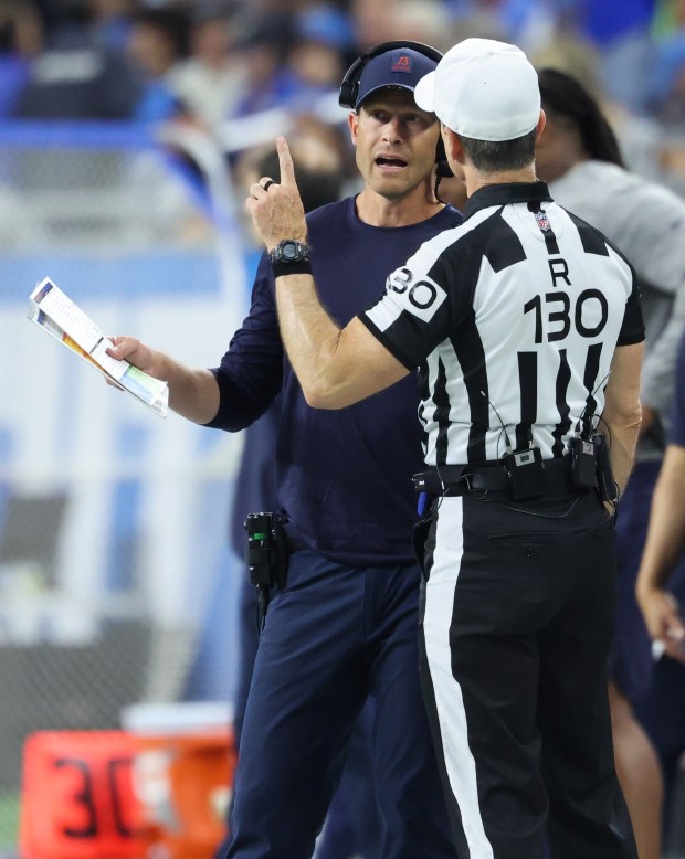 Bears coach Ben Johnson talks with an official in the...