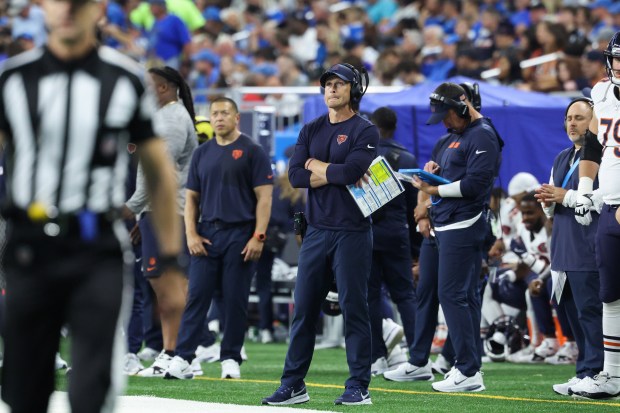 Bears coach Ben Johnson watches the video board in the...