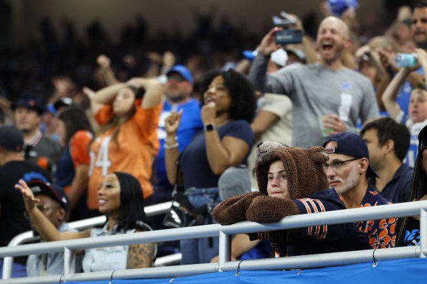 A fan in a bear costume watches as the Bears...