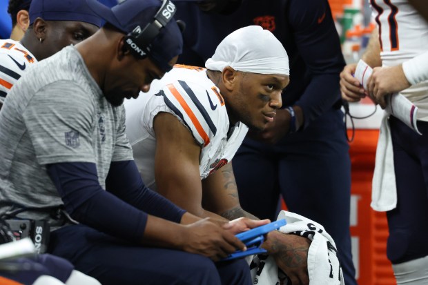 Bears wide receiver DJ Moore sits on the bench in...