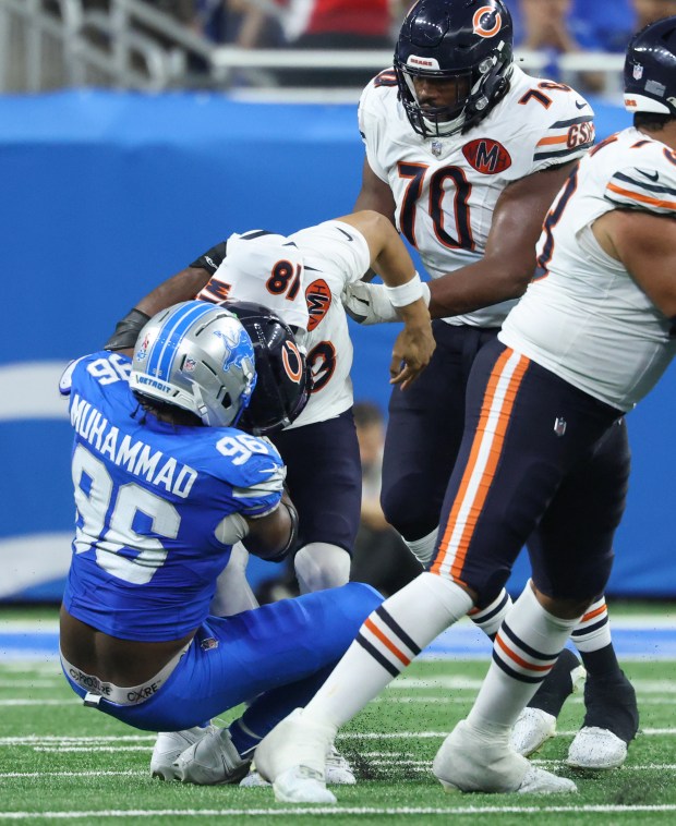 Lions linebacker Al-Quadin Muhammad sacks Bears quarterback Caleb Williams in...