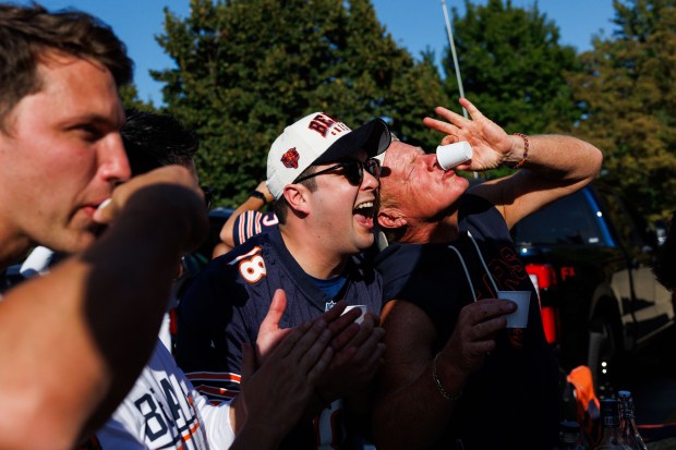 Mike Giacchetti, from left, Vito Giannini, Luigi Patino and Mike Carfagnini take a shot while tailgating outside Soldier Field before the Bears play the Minnesota Vikings on Sept. 8, 2025, in Chicago. (Armando L. Sanchez/Chicago Tribune)