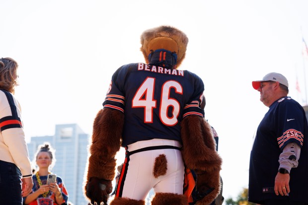 Don Wachter, known as "Bearman," poses with fans outside Soldier Field before the Bears play the Minnesota Vikings on Sept. 8, 2025, in Chicago. (Armando L. Sanchez/Chicago Tribune)