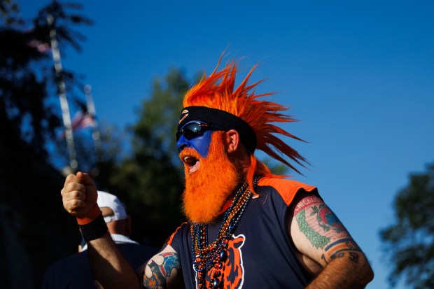 Michael Divartolomeo fist bumps fans outside Soldier Field before the Bears play the Minnesota Vikings on Sept. 8, 2025, in Chicago. (Armando L. Sanchez/Chicago Tribune)