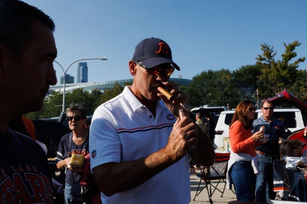 Tim Rose lights a cigar while tailgating outside Soldier Field before the Bears play the Minnesota Vikings on Sept. 8, 2025, in Chicago. (Armando L. Sanchez/Chicago Tribune)