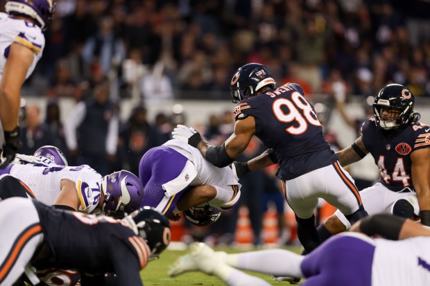 Minnesota Vikings quarterback J.J. McCarthy (9) gets sacked during the...