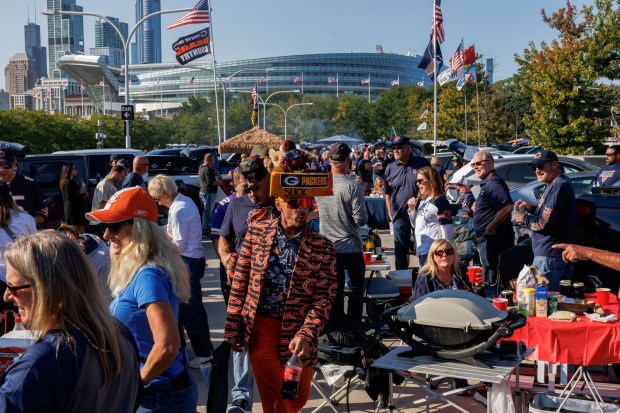 Wade Winters wears a “Packers suck” cheesehead while tailgating outside...