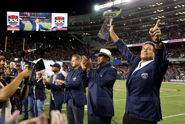 Dan Hampton holds the Vince Lombardi Trophy as the Chicago...