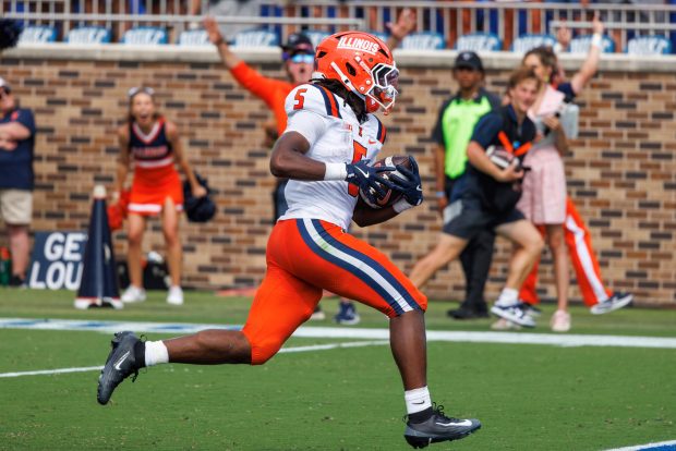 Illinois' Ca'Lil Valentine (5) carries the ball for a touchdown during the second half of an NCAA college football game against Duke in Durham, N.C., Saturday, Sept. 6, 2025. (AP Photo/Ben McKeown)