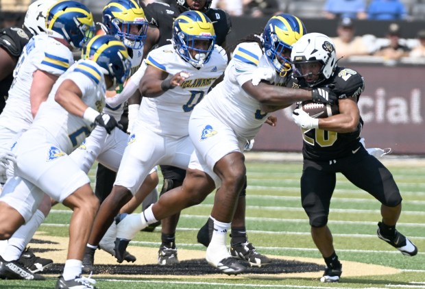 Colorado Buffaloes running back DeKalon Taylor breaks several tackles by...