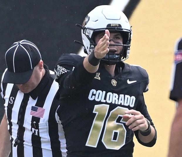 Colorado Buffaloes quarterback Ryan Staub signals a first down against...
