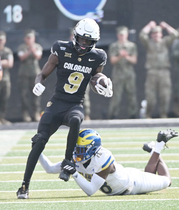 Colorado Buffaloes receiver Sincere Brown tries to get past Delaware...