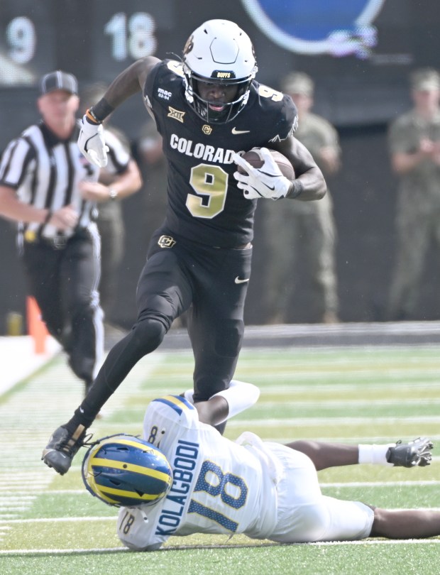 Colorado Buffaloes receiver Sincere Brown tries to get past Delaware...