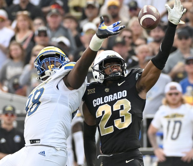 Colorado Buffaloes safety Carter Stoutmire, right, breaks up a pass...