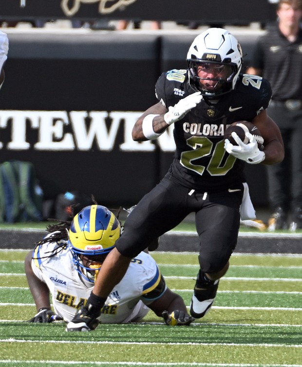 Colorado Buffaloes running back DeKalon Taylor breaks free from Delaware's...