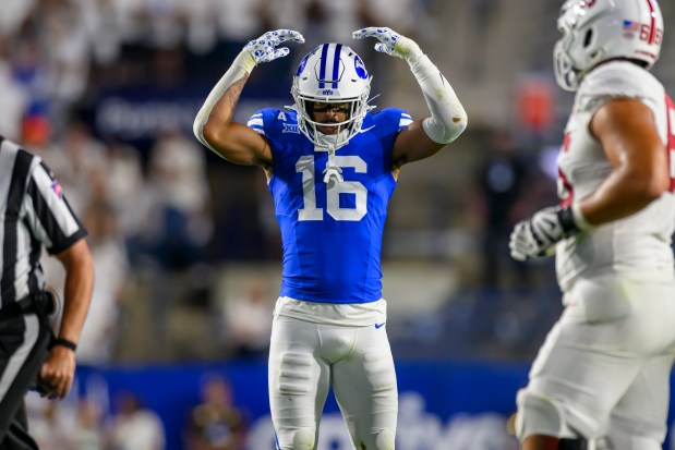 Brigham Young linebacker Isaiah Glasker (16) motions to the student section during an NCAA college football game against Stanford, Saturday, Sept. 6, 2025, in Provo, Utah. (AP Photo/Tyler Tate)