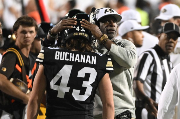 University of Colorado Buffaloes head coach Deion Sanders congratulates Colorado...