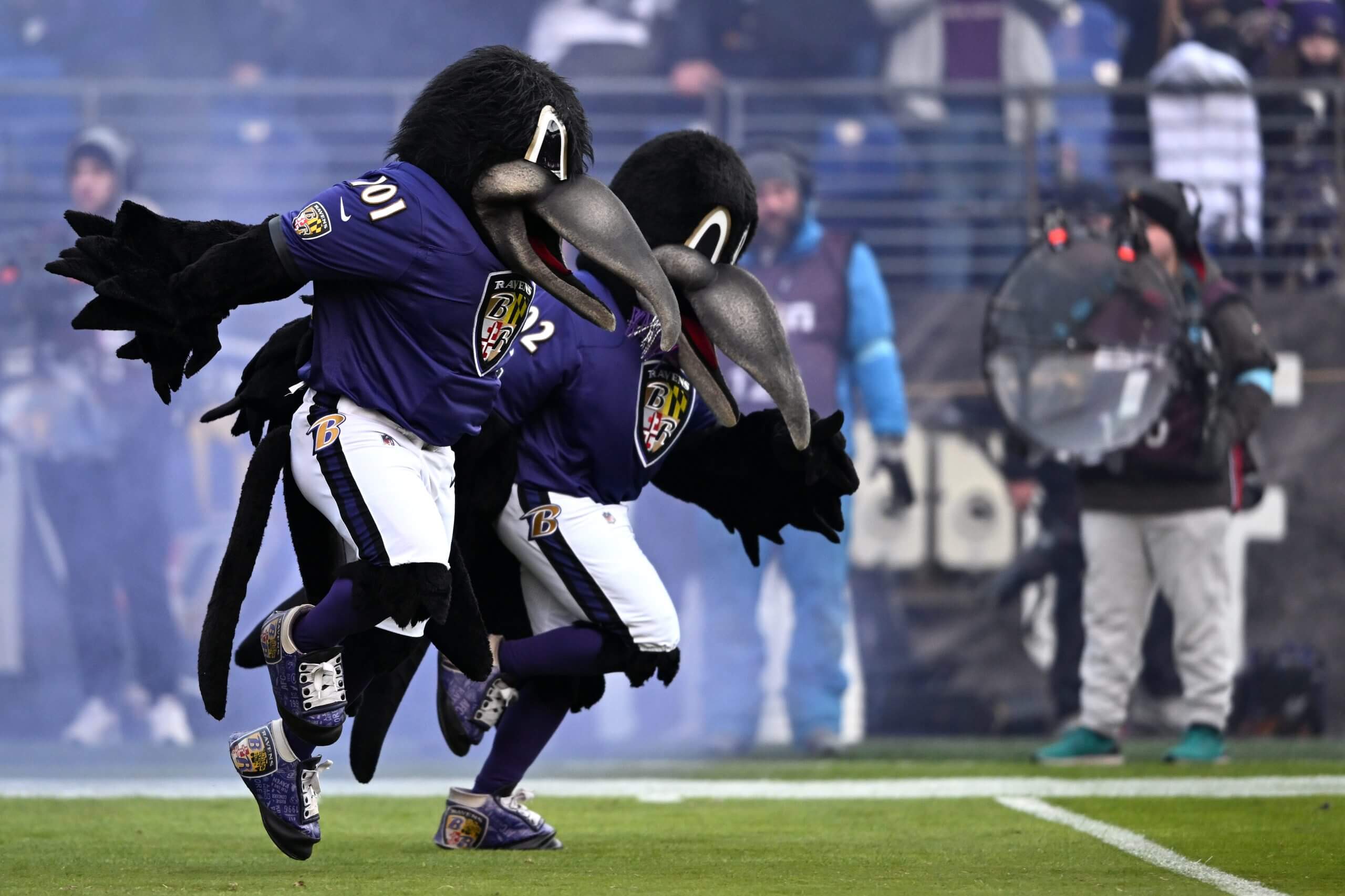 Poetry in motion, as Poe & Friends run out of the Ravens' tunnel. (Greg Fiume / Getty Images)