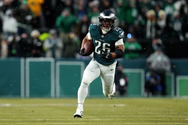PHILADELPHIA, PENNSYLVANIA - JANUARY 19: Saquon Barkley #26 of the Philadelphia Eagles runs the ball for a 62-yard touchdown against the Los Angeles Rams during the first quarter in the NFC Divisional Playoff at Lincoln Financial Field on January 19, 2025 in Philadelphia, Pennsylvania. (Photo by Mitchell Leff/Getty Images)