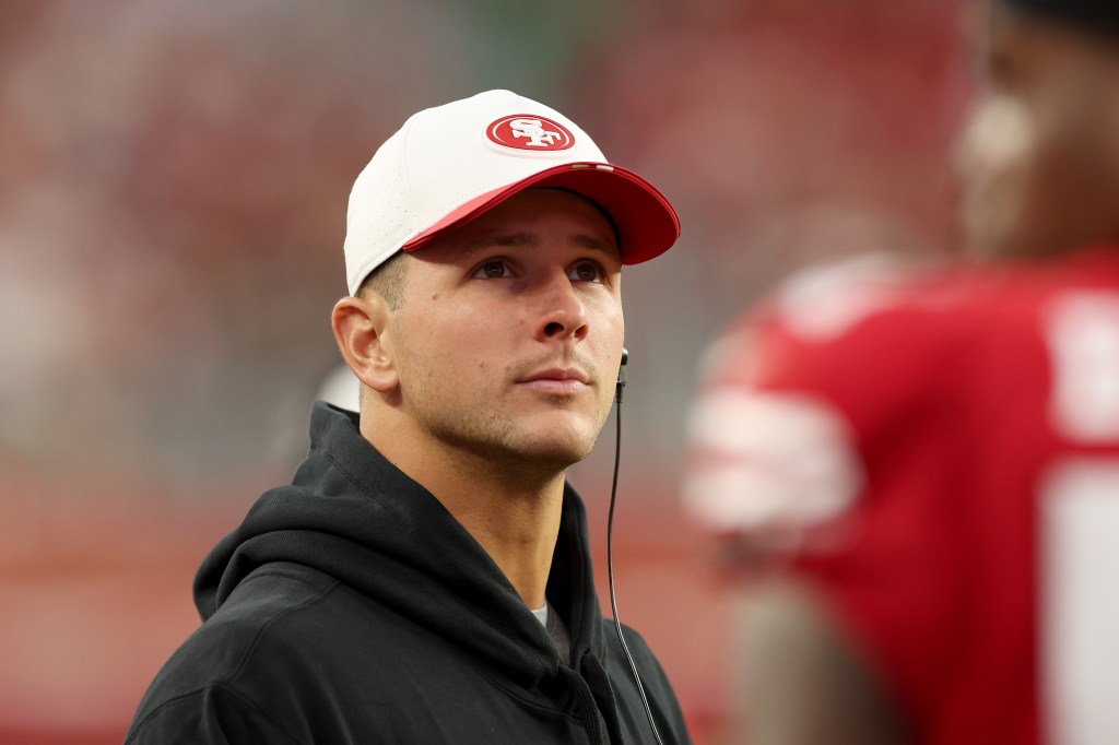 Brock Purdy stands on the sidelines during the NFL Preseason 2025 game between Los Angeles Chargers and San Francisco 49ers at Levi's Stadium on August 23, 2025 in Santa Clara, California.