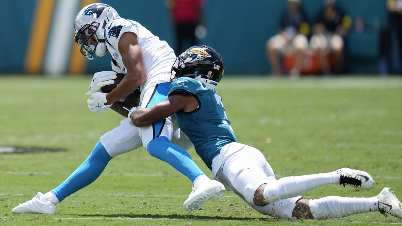 Jacksonville cornerback Tyson Campbell tackled Carolina wide receiver Tetairoa McMillan in the first half Sunday in Jacksonville, Fla.