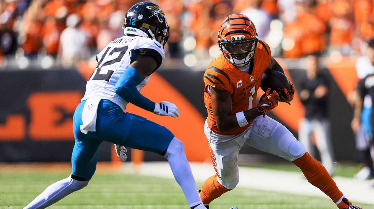 Cincinnati Bengals wide receiver Ja'Marr Chase (1) runs with the ball against Jacksonville Jaguars defensive back Travis Hunter (12) in the second half at Paycor Stadium.