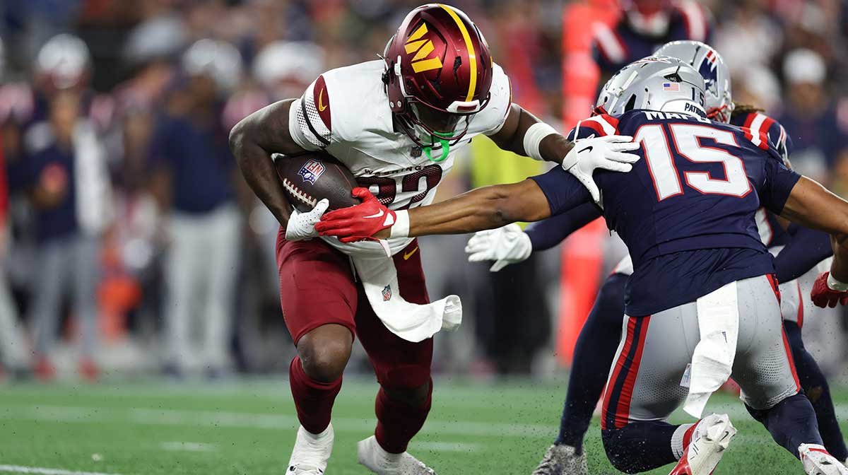 Washington Commanders running back Jacory Croskey-Merritt (32) runs the ball during the first half against the New England Patriots at Gillette Stadium.