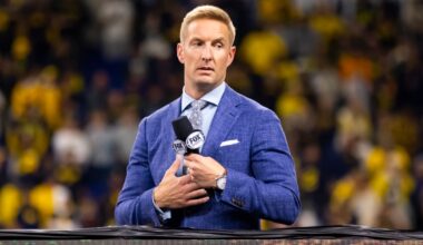 Notre Dame offensive lineman Trevor Ruhland with 2019 Camping World Trophy and wife Nina