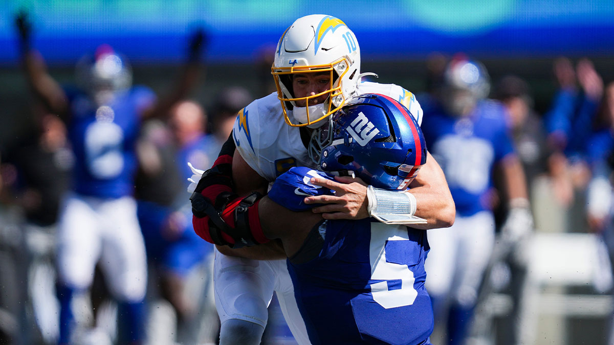 New York Giants linebacker Kayvon Thibodeaux (5) tackles Los Angeles Chargers quarterback Justin Herbert (10) during a game at MetLife Stadium, Sep 28, 2025, East Rutherford, NJ, USA.