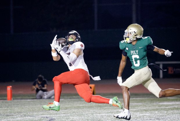 Tustins Devon Benavente (1) tries to make the catch in front of Long Beach Polys Zion Anderson (6) in Long Beach, CA, on Friday, Sept. 5, 2025. (Photo by Tracey Roman, Contributing Photographer)
