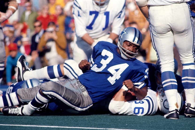 Safety Cornell Green (34) of the Dallas Cowboys tackles running back Norm Bulaich (36) of...
