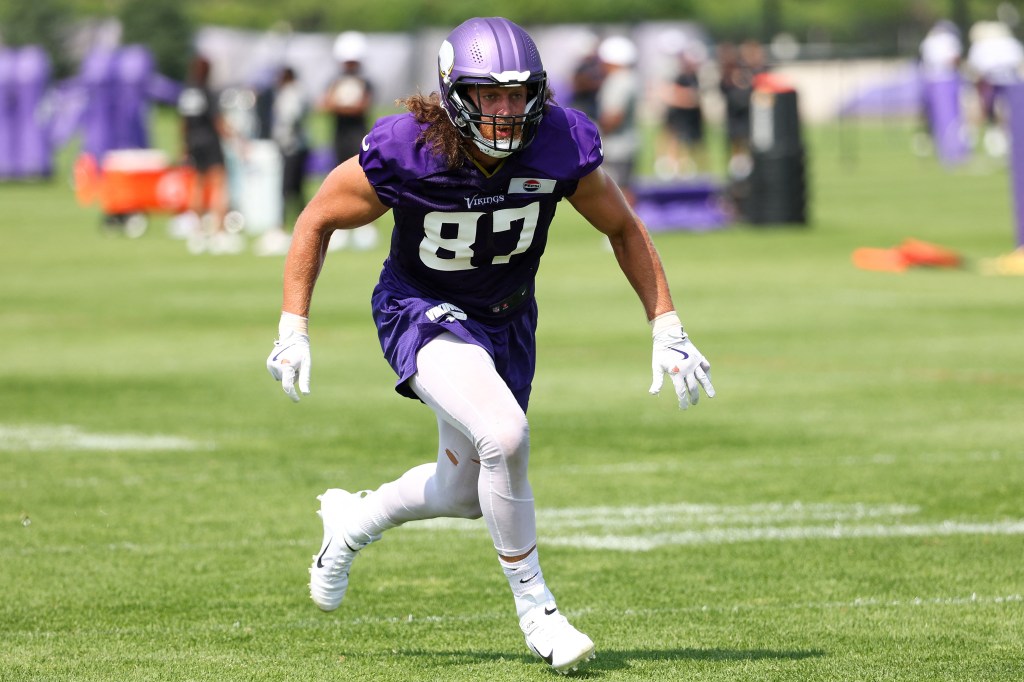 NFL Minnesota Vikings player #87 running on a field during training camp.