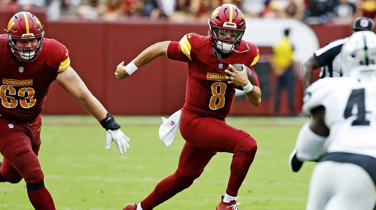 Washington Commanders quarterback Marcus Mariota (8) runs the ball during the first half against the Las Vegas Raiders at Northwest Stadium.