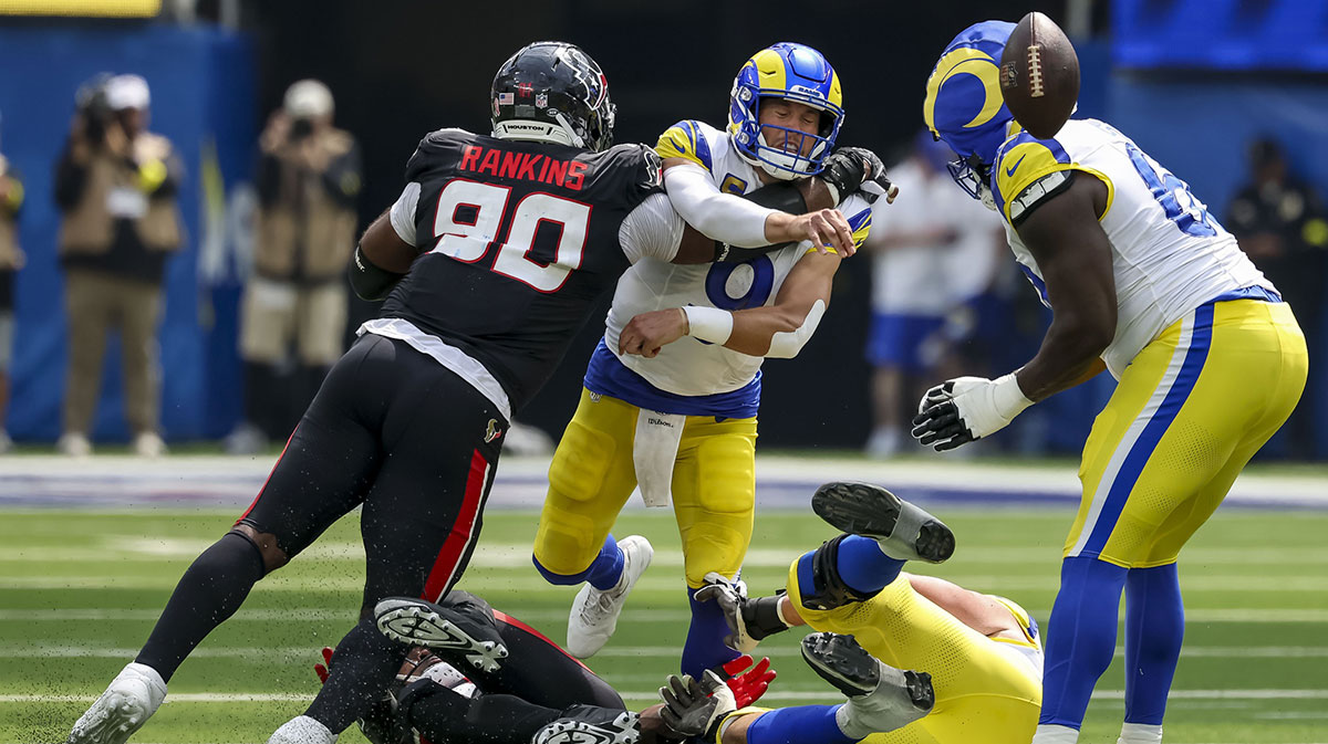 Los Angeles Rams defensive end Tyler Davis (90) shoves Los Angeles Rams quarterback Matthew Stafford (9) during the third quarter at SoFi Stadium.