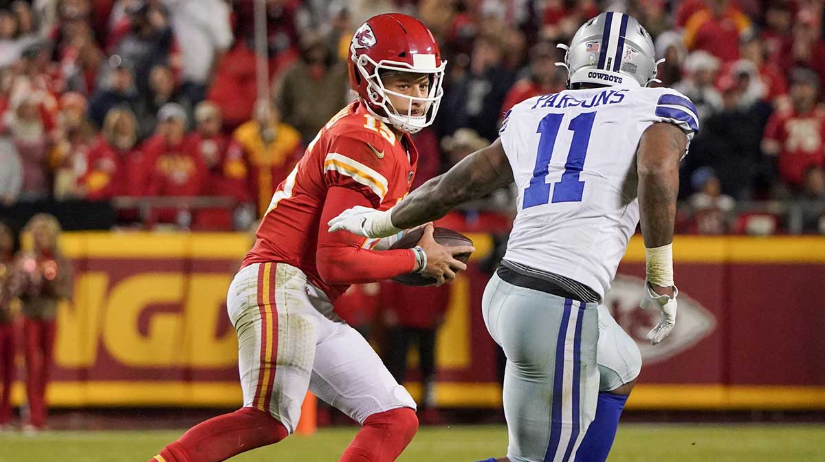 Kansas City Chiefs quarterback Patrick Mahomes (15) looks to pass as Dallas Cowboys outside linebacker Micah Parsons (11) defends during the game at GEHA Field at Arrowhead Stadium.