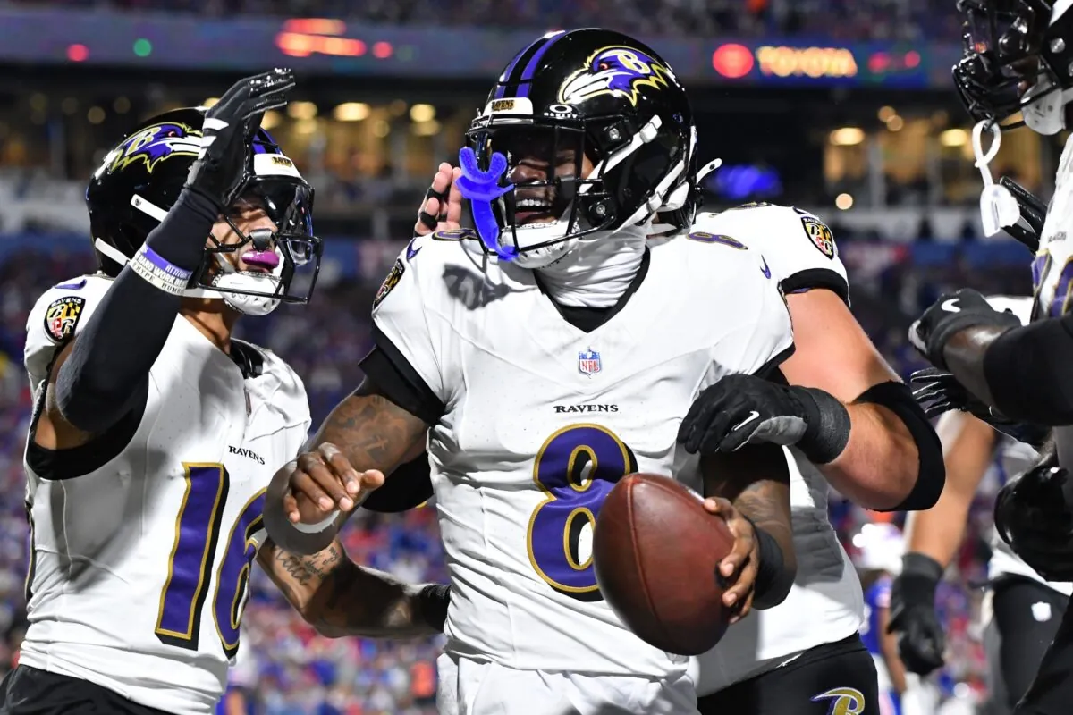 Baltimore Ravens quarterback Lamar Jackson (8) celebrates with wide receiver Tylan Wallace (16) after a touchdown against the Buffalo Bills during the first half at Highmark Stadium.