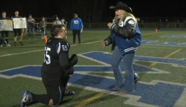 High school football player surprises girlfriend by proposing on field after senior night win