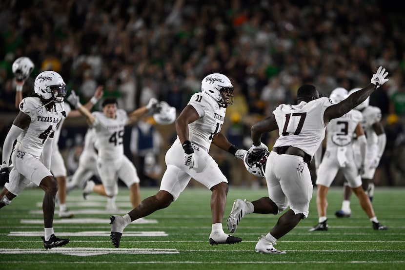 Texas A&M players run onto the field after defeating Notre Dame 41-40 in an NCAA football...